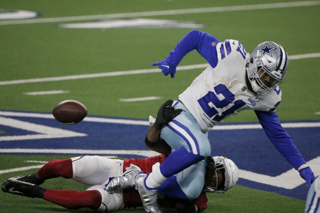 Arizona Cardinals safety Budda Baker (32) strips the ball from Dallas Cowboys running back Ezekiel Elliott (21) in the first half of an NFL football game in Arlington, Texas, Monday, Oct. 19, 2020. (AP Photo/Michael Ainsworth)