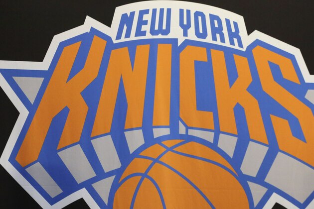 James Dolan, executive chairman of  Madison Square Garden, sits at a news conference next to the team logo where he introduced Phil Jackson as the new president of the New York Knicks, Tuesday, March 18, 2014 in New York. Jackson, who won two NBA titles as a player for the New York Knicks, also won 11 championships while coaching the Chicago Bulls and the Los Angeles Lakers. (AP Photo/Mark Lennihan)