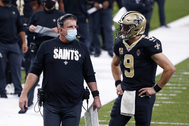 New Orleans Saints head coach Sean Payton talks with quarterback Drew Brees (9) in the first half of an NFL football game against the Los Angeles Chargers in New Orleans, Monday, Oct. 12, 2020. (AP Photo/Butch Dill)