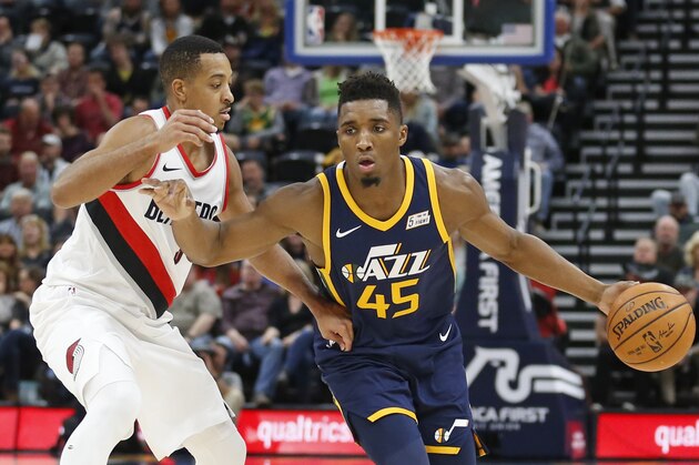 Portland Trail Blazers guard CJ McCollum, left, guards Utah Jazz guard Donovan Mitchell (45) as he drives in the first half during an NBA basketball game Wednesday, Nov. 1, 2017, in Salt Lake City. (AP Photo/Rick Bowmer)