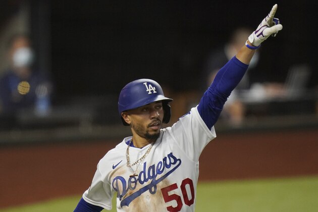 Los Angeles Dodgers' Mookie Betts celebrates a home run against the Tampa Bay Rays during the sixth inning in Game 1 of the baseball World Series Tuesday, Oct. 20, 2020, in Arlington, Texas. (AP Photo/Eric Gay)
