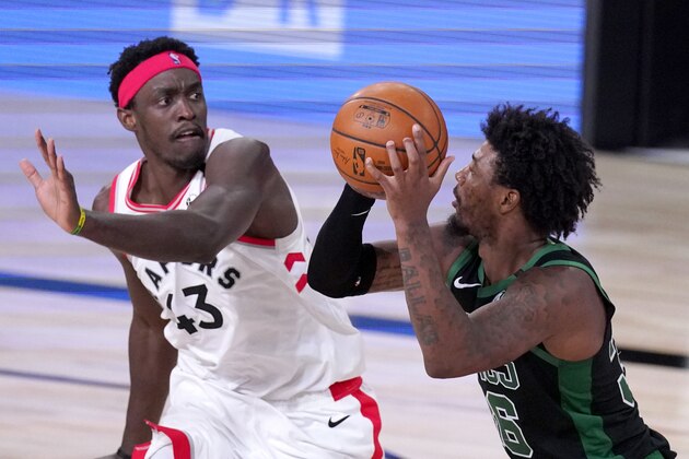Toronto Raptors' Pascal Siakam, left, defends against Boston Celtics' Marcus Smart during the first half of an NBA conference semifinal playoff basketball game Friday, Sept. 11, 2020, in Lake Buena Vista, Fla. (AP Photo/Mark J. Terrill)