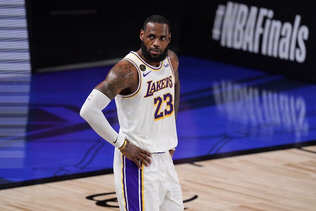 Los Angeles Lakers' LeBron James (23) looks on during the first half in Game 3 of basketball's NBA Finals against the Miami Heat, Sunday, Oct. 4, 2020, in Lake Buena Vista, Fla. (AP Photo/Mark J. Terrill)