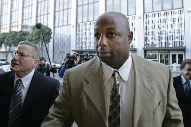 Former NFL football player Dana Stubblefield, front, leaves a federal courthouse with his attorney Mike Armstrong, left, in San Francisco, Friday, Jan. 18, 2008. Stubblefield pleaded guilty Friday to lying to investigators in the BALCO steroids case, making him the first football player charged in the long-running federal investigation. (AP Photo/Paul Sakuma)