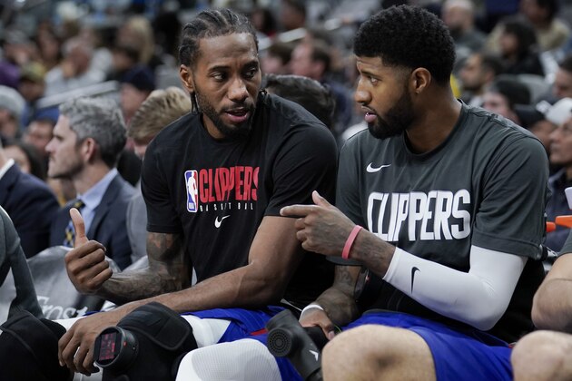 Los Angeles Clippers' Kawhi Leonard, left, and Paul George talk on the bench during the second half of an NBA basketball game against the San Antonio Spurs, Saturday, Dec. 21, 2019, in San Antonio. Los Angeles won 134-109. (AP Photo/Darren Abate) Los Angeles Clippers' Kawhi Leonard, left, and Paul George talk on the bench during the second half of an NBA basketball game against the San Antonio Spurs, Saturday, Dec. 21, 2019, in San Antonio. Los Angeles won 134-109. (AP Photo/Darren Abate)