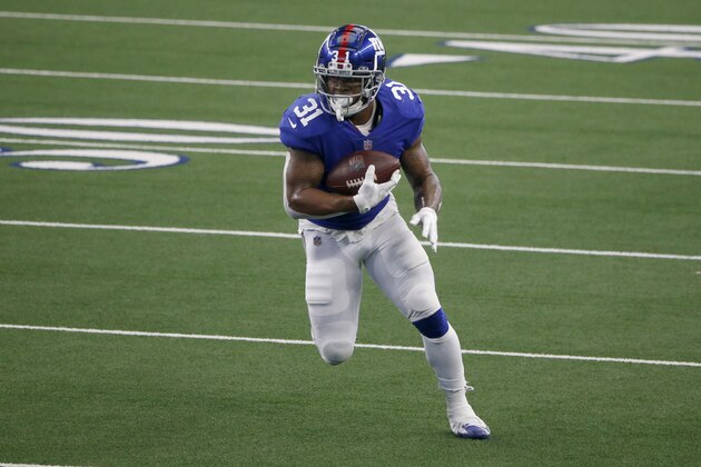 New York Giants running back Devonta Freeman (31) runs against the Dallas Cowboys during the first half of an NFL Football game in Arlington, Texas, Sunday, Oct. 11, 2020. (AP Photo/Michael Ainsworth)