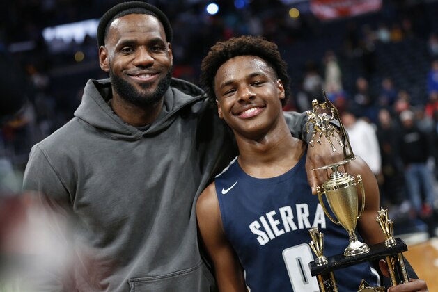 LeBron James, left, poses with his son Bronny after Sierra Canyon beat Akron St. Vincent - St. Mary in a high school basketball game, Saturday, Dec. 14, 2019, in Columbus, Ohio. (AP Photo/Jay LaPrete)