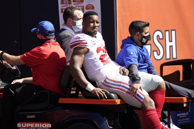 New York Giants running back Saquon Barkley (26) is carted to the locker room after being injured during the first half of an NFL football game against the Chicago Bears in Chicago, Sunday, Sept. 20, 2020. (AP Photo/Nam Y. Huh)