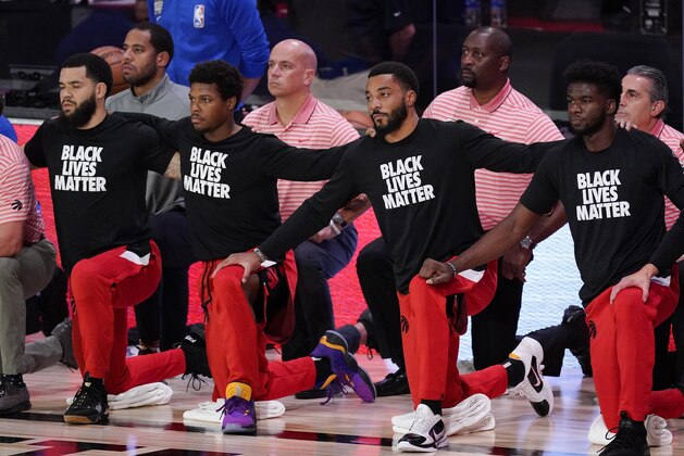 Members of the Toronto Raptors kneel on the court during the playing of the national anthem before an NBA conference semifinal playoff basketball game against the Boston Celtics Saturday, Sept. 5, 2020, in Lake Buena Vista, Fla. (AP Photo/Mark J. Terrill) Members of the Toronto Raptors kneel on the court during the playing of the national anthem before an NBA conference semifinal playoff basketball game against the Boston Celtics Saturday, Sept. 5, 2020, in Lake Buena Vista, Fla. (AP Photo/Mark J. Terrill)