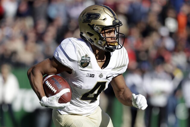 FILE - In this Dec. 28, 2018, file photo, Purdue wide receiver Rondale Moore runs against Auburn in the first half of the Music City Bowl NCAA college football game, in Nashville, Tenn. Purdue receiver Rondale Moore and Nevada running back Toa Taua each made a big mark on his respective team as a freshman. Now it’s time to see what they’ll do for an encore, beginning Friday night when Nevada hosts Purdue in the season opener for both teams. (AP Photo/Mark Humphrey, File)