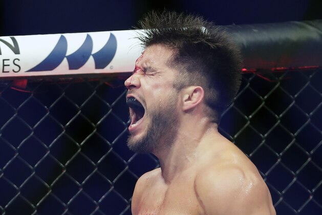 Henry Cejudo celebrates after winning his bout against Dominick Cruz in a UFC 249 mixed martial arts event, Saturday, May 9, 2020, in Jacksonville, Fla. (AP Photo/John Raoux)