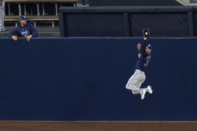 Tampa Bay Rays center fielder Kevin Kiermaier makes a leaping catch on a fly ball by Houston Astros Alex Bregman during the first inning in Game 3 of a baseball American League Championship Series, Tuesday, Oct. 13, 2020, in San Diego. (AP Photo/Gregory Bull) Tampa Bay Rays center fielder Kevin Kiermaier makes a leaping catch on a fly ball by Houston Astros Alex Bregman during the first inning in Game 3 of a baseball American League Championship Series, Tuesday, Oct. 13, 2020, in San Diego. (AP Photo/Gregory Bull)