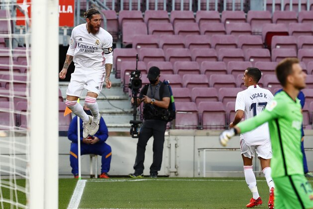 Real Madrid's Sergio Ramos scores his side's 2nd goal during the Spanish La Liga soccer match between FC Barcelona and Real Madrid at the Camp Nou stadium in Barcelona, Spain, Saturday, Oct. 24, 2020. (AP Photo/Joan Monfort)