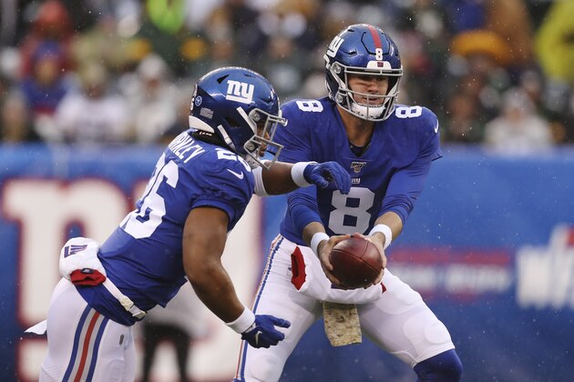 New York Giants quarterback Daniel Jones (8) hands the ball off to New York Giants running back Saquon Barkley (26) during the first half of an NFL football game against the Green Bay Packers, Sunday, Dec. 1, 2019, in East Rutherford, N.J. The Green Bay Packers won 31-13. (AP Photo/Steve Luciano)
