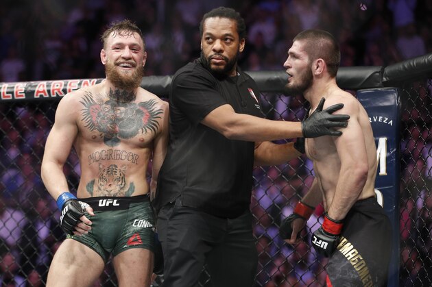Conor McGregor, left, fights Khabib Nurmagomedov during a UFC 229 mixed martial arts bout Saturday, Oct. 6, 2018, in Las Vegas. (AP Photo/John Locher)