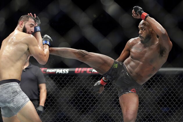 File - In this Feb. 8, 2020, file photo, Jon Jones, right, kicks Dominick Reyes during a light heavyweight mixed martial arts bout at UFC 247 in Houston. The long-reigning UFC light heavyweight champion,  Jones says he is vacating his title and likely moving up to heavyweight. Jones made the declarations on Twitter on Monday, Aug. 17, 2020, although the UFC didn't immediately confirm them. (AP Photo/Michael Wyke, File)