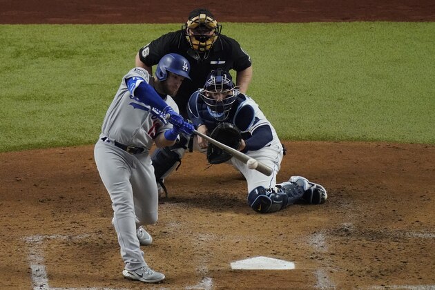 Los Angeles Dodgers' Max Muncy his a two-RBI single against the Tampa Bay Rays during the third inning in Game 3 of the baseball World Series Friday, Oct. 23, 2020, in Arlington, Texas. (AP Photo/Sue Ogrocki)