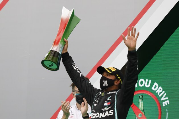 Mercedes driver Lewis Hamilton of Britain celebrates after winning the Formula One Portuguese Grand Prix at the Algarve International Circuit in Portimao, Portugal, Sunday, Oct. 25, 2020. (Rafael Marchante, Pool via AP) Mercedes driver Lewis Hamilton of Britain celebrates after winning the Formula One Portuguese Grand Prix at the Algarve International Circuit in Portimao, Portugal, Sunday, Oct. 25, 2020. (Rafael Marchante, Pool via AP)