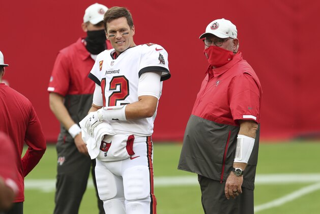 Tampa Bay Buccaneers quarterback Tom Brady (12) talks to head coach Bruce Arians before an NFL football game against the Los Angeles Chargers Sunday, Oct. 4, 2020, in Tampa, Fla. (AP Photo/Mark LoMoglio)