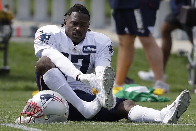 FILE - In this Wednesday, Sept. 18, 2019, file photo, New England Patriots wide receiver Antonio Brown puts on his  Nike cleats during NFL football practice in Foxborough, Mass. Nike has dropped Brown, Nike spokesman Josh Benedek told The Associated Press on Friday, Sept. 20, 2019. The move comes after a second woman accused Brown of sexual assault.   (AP Photo/Steven Senne, File)