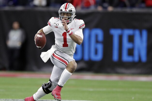 FILE - In this Dec. 7, 2019, file photo, Ohio State quarterback Justin Fields (1) runs with the ball against Wisconsin during the first half of the Big Ten championship NCAA college football game, in Indianapolis. The Big Ten won't play football this fall because of concerns about COVID-19, becoming the first of college sports' power conferences to yield to the pandemic. The move announced Tuesday, Aug. 11, 2020, comes six day after the conference that includes historic programs such as Ohio State, Michigan, Nebraska and Penn State had released a revised conference-only schedule that it hoped would help it navigate a fall season with potential COVID-19 disruptions. (AP Photo/Michael Conroy, File) FILE - In this Dec. 7, 2019, file photo, Ohio State quarterback Justin Fields (1) runs with the ball against Wisconsin during the first half of the Big Ten championship NCAA college football game, in Indianapolis. The Big Ten won't play football this fall because of concerns about COVID-19, becoming the first of college sports' power conferences to yield to the pandemic. The move announced Tuesday, Aug. 11, 2020, comes six day after the conference that includes historic programs such as Ohio State, Michigan, Nebraska and Penn State had released a revised conference-only schedule that it hoped would help it navigate a fall season with potential COVID-19 disruptions. (AP Photo/Michael Conroy, File)