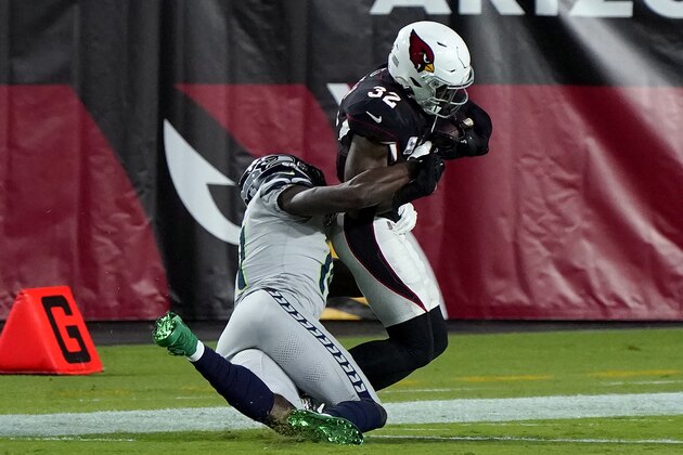 Seattle Seahawks wide receiver DK Metcalf tackles Arizona Cardinals strong safety Budda Baker (32) short of the goal line after Baker intercepted a pass during the first half of an NFL football game, Sunday, Oct. 25, 2020, in Glendale, Ariz. (AP Photo/Rick Scuteri)