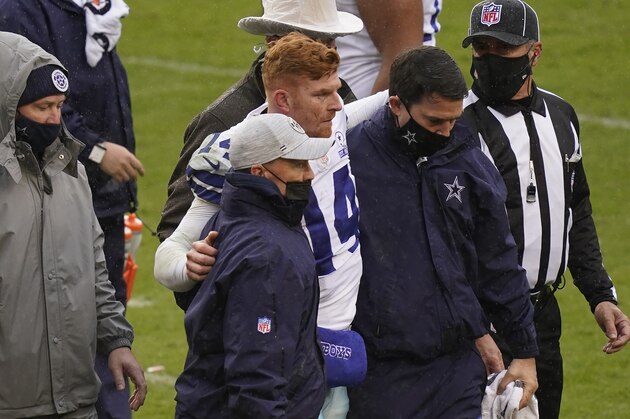 Dallas Cowboys quarterback Andy Dalton (14) is helped off the field after getting hit by Washington Football Team inside linebacker Jon Bostic (53) in the second half of an NFL football game, Sunday, Oct. 25, 2020, in Landover, Md. (AP Photo/Patrick Semansky)
