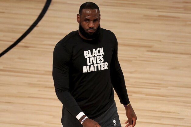 Los Angeles Lakers' LeBron James wears a Black Lives Matter shirt as he takes to the court prior to an NBA basketball game against the Los Angeles Clippers, Thursday, July 30, 2020, in Lake Buena Vista, Fla. (Mike Ehrmann/Pool Photo via AP)