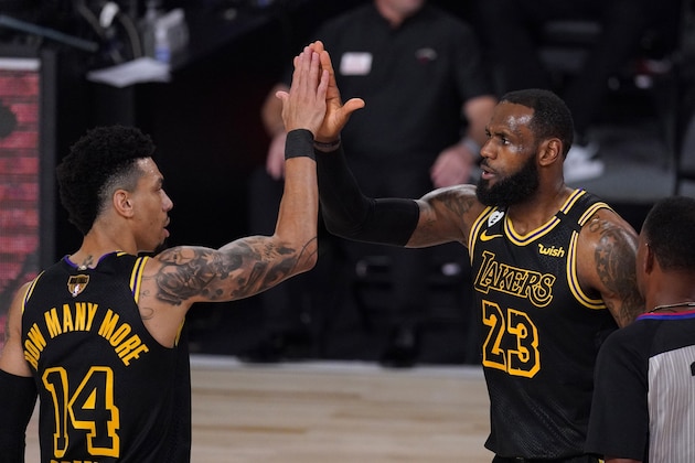 Los Angeles Lakers' Danny Green (14) and LeBron James (23) celebrate a basket by James during the second half of Game 2 of basketball's NBA Finals against the Miami Heat on Friday, Oct. 2, 2020, in Lake Buena Vista, Fla. (AP Photo/Mark J. Terrill)