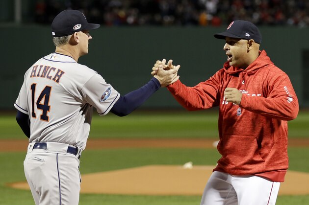 Houston Astros manager AJ Hinch, left, and Boston Red Sox manager Alex Cora shake Hanes before Game 1 of a baseball American League Championship Series on Saturday, Oct. 13, 2018, in Boston. (AP Photo/David J. Phillip)