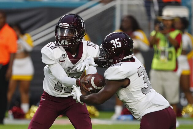 Bethune Cookman quarterback Devin Black hands off to running back Aaron Thompson (35) during the second half of an NCAA college football game against Miami, Saturday, Sept. 14, 2019, in Miami Gardens, Fla. Miami defeated Bethune Cookman 63-0. (AP Photo/Wilfredo Lee)
