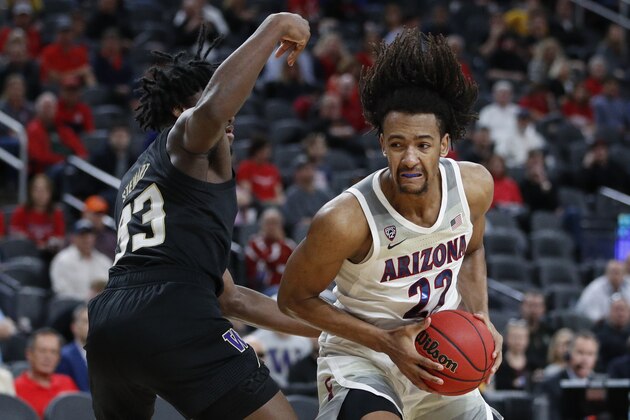 Arizona's Zeke Nnaji (22) drives into Washington's Isaiah Stewart (33) during the second half of an NCAA college basketball game in the first round of the Pac-12 men's tournament Wednesday, March 11, 2020, in Las Vegas. (AP Photo/John Locher) Arizona's Zeke Nnaji (22) drives into Washington's Isaiah Stewart (33) during the second half of an NCAA college basketball game in the first round of the Pac-12 men's tournament Wednesday, March 11, 2020, in Las Vegas. (AP Photo/John Locher)