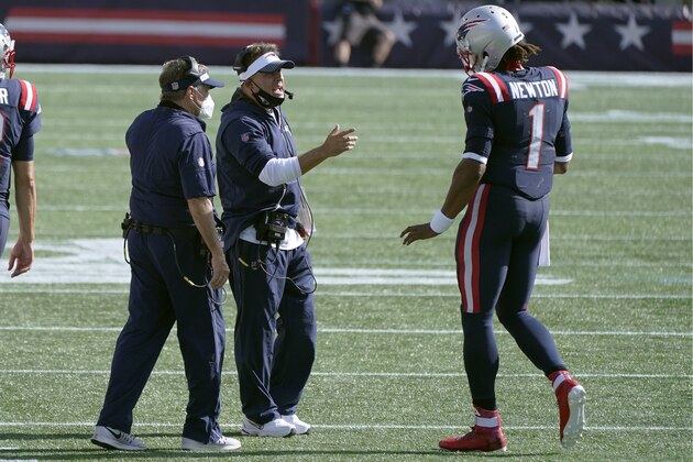 New England Patriots offensive coordinator Josh McDaniels, center, speaks to quarterback Cam Newton on the sideline in the second half of an NFL football game against the Miami Dolphins, Sunday, Sept. 13, 2020, in Foxborough, Mass. At left is head coach Bill Belichick. (AP Photo/Steven Senne)