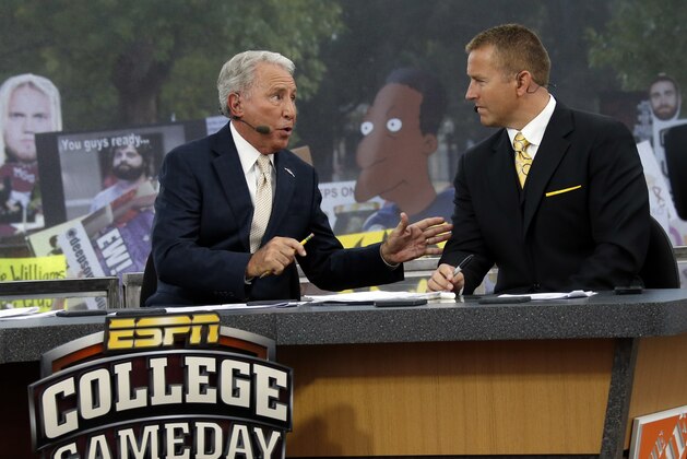 FILE - In this Oct. 11, 2014, file photo, ESPN College GameDay hosts Lee Corso, left, and Kirk Herbstreit confer during the telecast from The Junction prior to Mississippi State playing Auburn in an NCAA college football game in Starkville, Miss. This week the Cornhuskers are front and center. Their game against No. 5 Ohio State on Saturday night was always going to be a big one. Add a visit from ESPN’s “College GameDay” show in the morning, and it becomes huge. (AP Photo/Rogelio V. Solis, File)