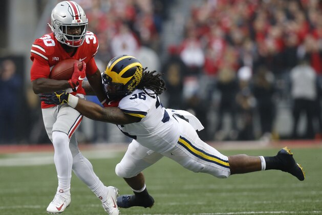 Michigan linebacker Devin Gil, right, tackles Ohio State running back Demario McCall during the first half of an NCAA college football game Saturday, Nov. 24, 2018, in Columbus, Ohio. (AP Photo/Jay LaPrete)