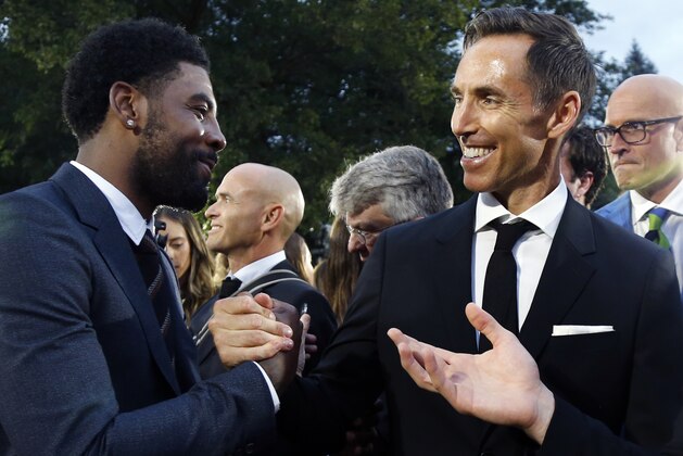 Steve Nash, right, greets Kyrie Irving on the red carpet before induction ceremonies into the Basketball Hall of Fame, Friday, Sept. 7, 2018, in Springfield, Mass. (AP Photo/Elise Amendola)