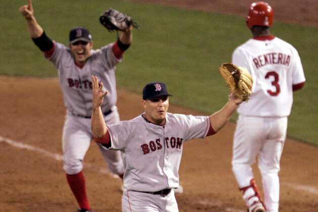 ** FILE ** Boston Red Sox pitcher Keith Foulke, center, and first baseman Doug Mientkiewicz, left, celebrate after St. Louis Cardinals' Edgar Renteria (3) grounded out to end the ninth inning and give Boston a 4-0 win and a sweep of the World Series, in this Oct. 27, 2004 file photo, in St. Louis. Foulke, whose toss to first base for the final out ended an 86-year World Series title drought for the Boston Red Sox, retired Friday just as he was about to begin a two-man competition with Joe Borowski to be Cleveland's closer.  (AP Photo/Mark Humphrey)
