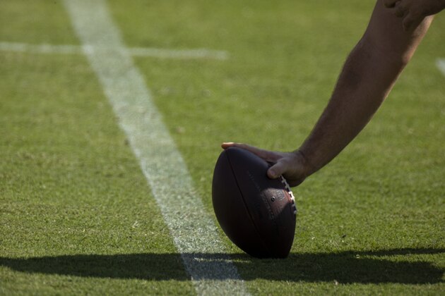Detail view of an NFL football held in the snapping position by Tennessee Titans offensive tackle Ty Sambrailo (70) as he warms up before an NFL football game against the Jacksonville Jaguars, Sunday, Sept. 20, 2020, in Nashville, Tenn. (AP Photo/Brett Carlsen)