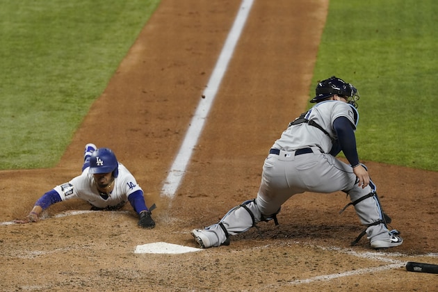 CORRECTS TO SIXTH INNING, INSTEAD OF FIFTH - Los Angeles Dodgers' Mookie Betts scores past Tampa Bay Rays catcher Mike Zunino during the sixth inning in Game 6 of the baseball World Series Tuesday, Oct. 27, 2020, in Arlington, Texas. (AP Photo/David J. Phillip) CORRECTS TO SIXTH INNING, INSTEAD OF FIFTH - Los Angeles Dodgers' Mookie Betts scores past Tampa Bay Rays catcher Mike Zunino during the sixth inning in Game 6 of the baseball World Series Tuesday, Oct. 27, 2020, in Arlington, Texas. (AP Photo/David J. Phillip)