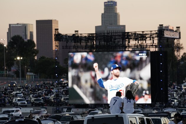 Baseball fans sit in their cars outside Dodger Stadium and watch the television broadcast of Game 6 of the World Series between the Los Angeles Dodgers and the Tampa Bay Rays on Tuesday, Oct. 27, 2020, in Los Angeles. (AP Photo/Ashley Landis) Baseball fans sit in their cars outside Dodger Stadium and watch the television broadcast of Game 6 of the World Series between the Los Angeles Dodgers and the Tampa Bay Rays on Tuesday, Oct. 27, 2020, in Los Angeles. (AP Photo/Ashley Landis)