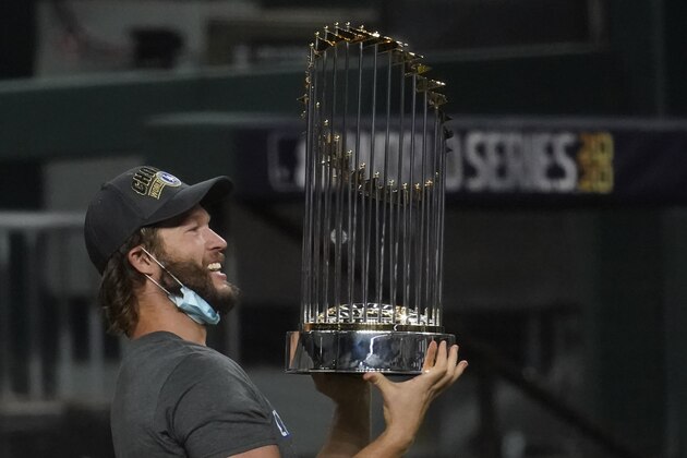 Los Angeles Dodgers pitcher Clayton Kershaw celebrates with the trophy after defeating the Tampa Bay Rays 3-1 to win the baseball World Series in Game 6 Tuesday, Oct. 27, 2020, in Arlington, Texas. (AP Photo/Tony Gutierrez) Los Angeles Dodgers pitcher Clayton Kershaw celebrates with the trophy after defeating the Tampa Bay Rays 3-1 to win the baseball World Series in Game 6 Tuesday, Oct. 27, 2020, in Arlington, Texas. (AP Photo/Tony Gutierrez)