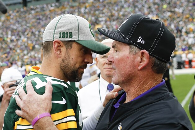 Minnesota Vikings head coach Mike Zimmer talks to Green Bay Packers' Aaron Rodgers after an NFL football game Sunday, Sept. 15, 2019, in Green Bay, Wis. The Packers won 21-16. (AP Photo/Matt Ludtke)