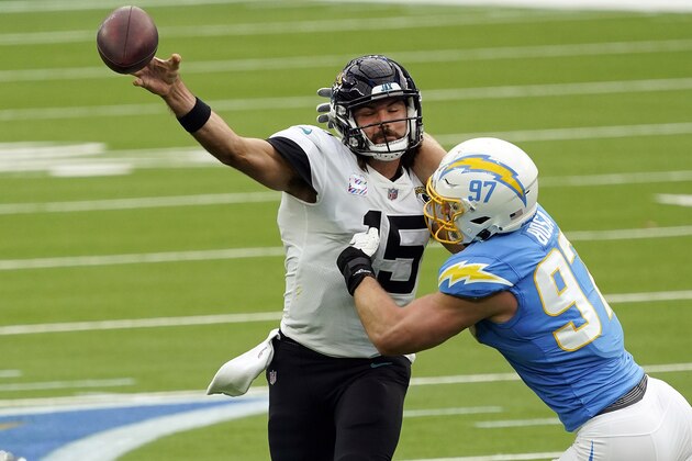 Jacksonville Jaguars quarterback Gardner Minshew, left, throws under pressure from Los Angeles Chargers defensive end Joey Bosa during the first half of an NFL football game Sunday, Oct. 25, 2020, in Inglewood, Calif. (AP Photo/Alex Gallardo ) Jacksonville Jaguars quarterback Gardner Minshew, left, throws under pressure from Los Angeles Chargers defensive end Joey Bosa during the first half of an NFL football game Sunday, Oct. 25, 2020, in Inglewood, Calif. (AP Photo/Alex Gallardo )