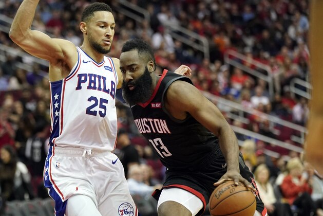 Houston Rockets' James Harden (13) drives toward the basket as Philadelphia 76ers' Ben Simmons (25) defends during the second half of an NBA basketball game Friday, March 8, 2019, in Houston. (AP Photo/David J. Phillip)