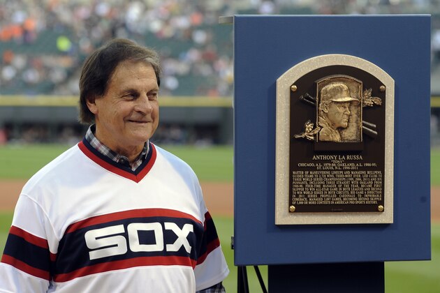 FILE - In this Aug. 30, 2014, file photo, former Chicago White Sox manager Tony La Russa stands with his Baseball Hall of Fame plaque before the second baseball game of a doubleheader against the Detroit Tigers in Chicago. La Russa, the Hall of Famer who won a World Series championship with the Oakland Athletics and two more with the St. Louis Cardinals, is returning to manage the Chicago White Sox 34 years after they fired him, the team announced Thursday, Oct. 29, 2020. (AP Photo/Matt Marton, File)