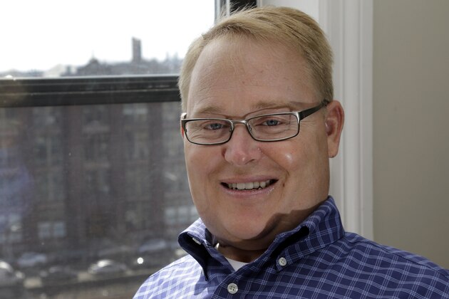 FILEâ€” In this April 15, 2015, file photo, former Boston University hockey player Travis Roy poses in his apartment in downtown Boston. Roy, who was paralyzed 11 seconds into his first game and went on to be a motivational speaker and advocate for the disabled, has died. He was 45. The BU athletic department confirmed his death in a statement posted on Facebook. (AP Photo/Elise Amendola, File)