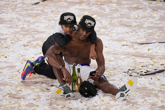 Los Angeles Lakers' Rajon Rondo sits in the confetti with his son Rajon Jr. after the Lakers defeated the Miami Heat 106-93 in Game 6 of basketball's NBA Finals, Sunday, Oct. 11, 2020, in Lake Buena Vista, Fla. (AP Photo/Mark J. Terrill) Los Angeles Lakers' Rajon Rondo sits in the confetti with his son Rajon Jr. after the Lakers defeated the Miami Heat 106-93 in Game 6 of basketball's NBA Finals, Sunday, Oct. 11, 2020, in Lake Buena Vista, Fla. (AP Photo/Mark J. Terrill)