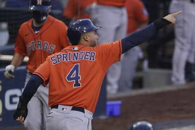 Houston Astros George Springer reacts after scoring on a single by Jose Altuve against the Tampa Bay Rays during the fifth inning in Game 6 of a baseball American League Championship Series, Friday, Oct. 16, 2020, in San Diego. (AP Photo/Ashley Landis)