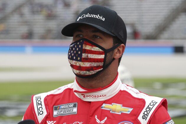 Bubba Wallace (43) waits on the grid before a NASCAR Cup Series auto race at Texas Motor Speedway in Fort Worth, Texas, Sunday, Oct. 25, 2020. (AP Photo/Richard W. Rodriguez)