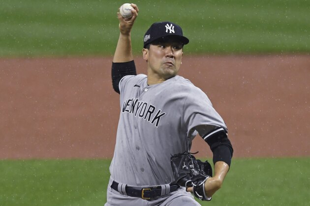 New York Yankees starting pitcher Masahiro Tanaka winds up during the first inning of Game 2 of the team's American League wild-card baseball series against the Cleveland Indians, Wednesday, Sept. 30, 2020, in Cleveland. (AP Photo/David Dermer)